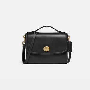 COACH
Kip Turn-lock Leather Crossbody COLOR:
Brass/Black Couple Scratch’s